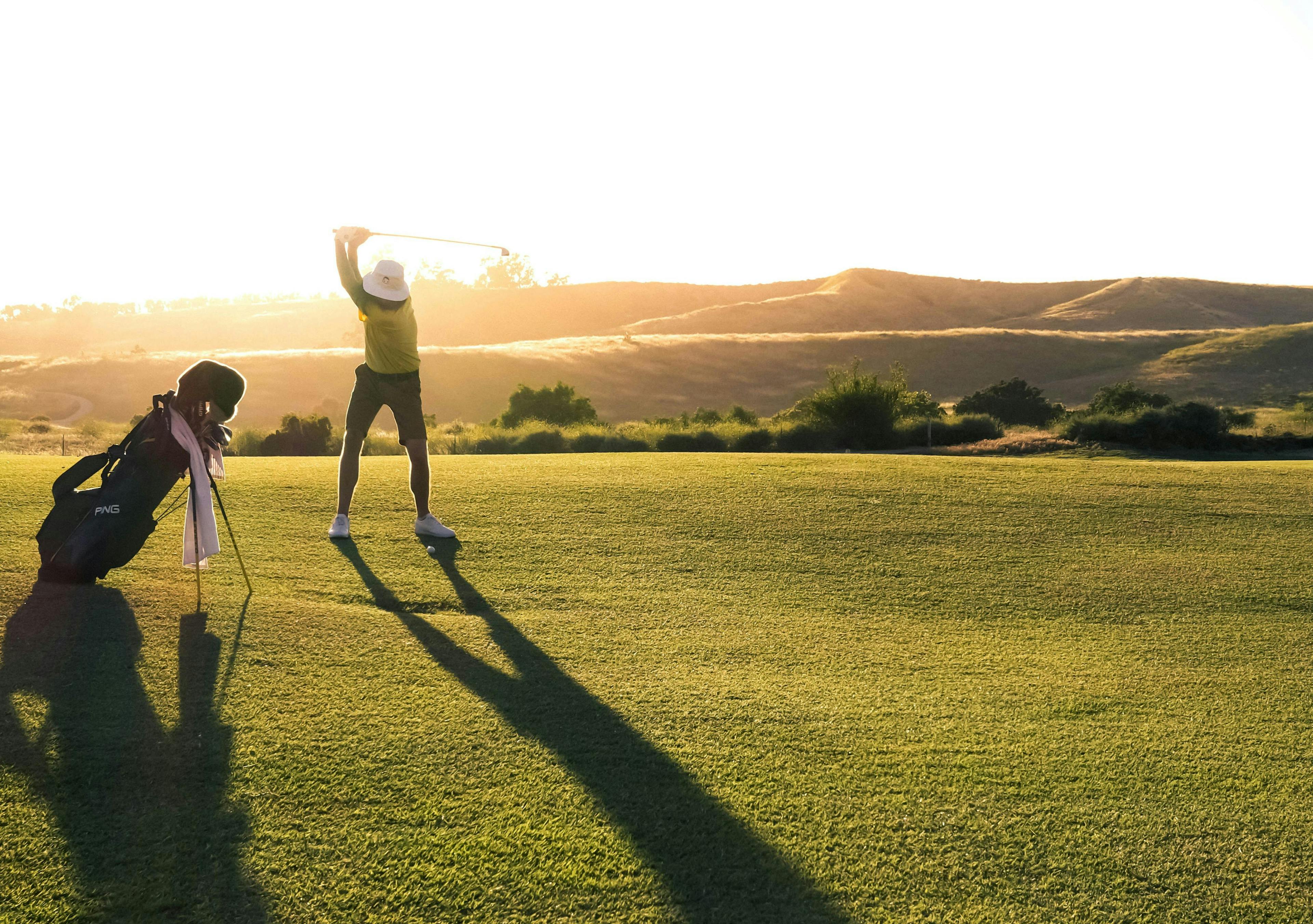 Golfer Swinging Sunset